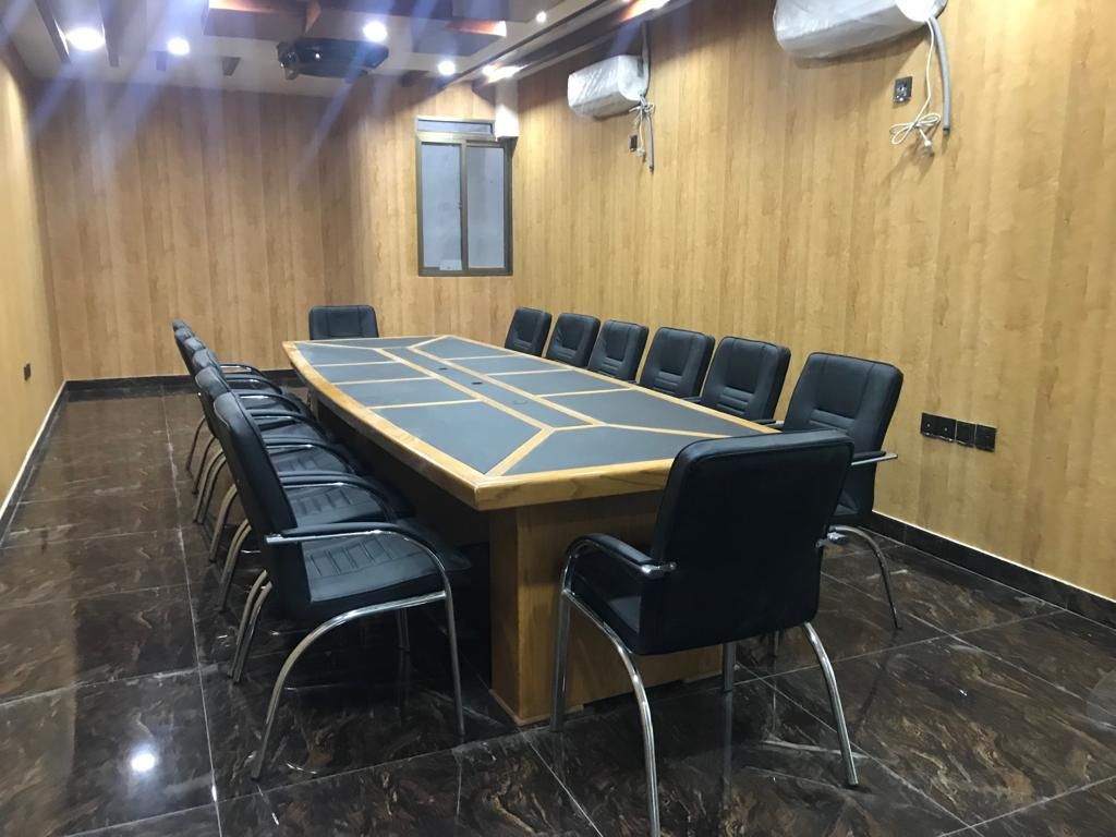 Conference room with a long meeting table at the head office