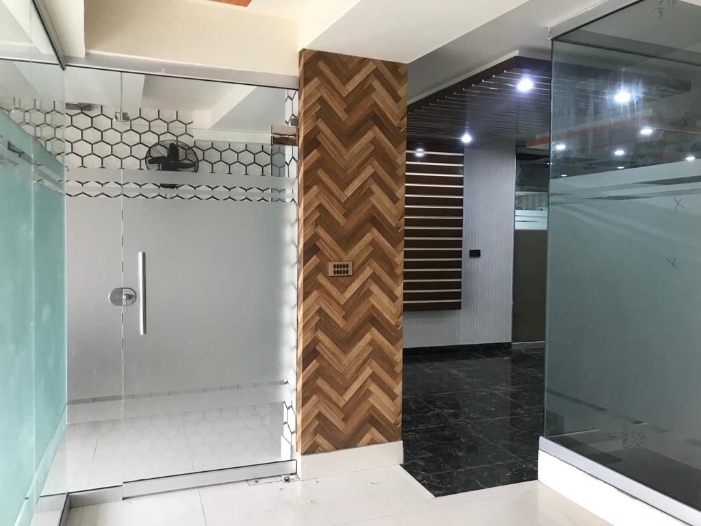 Glass-partitioned office entrance beside a timber feature column at the head office