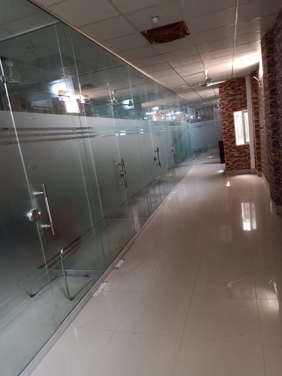 Corridor of glass-fronted offices at the Kandh Kot branch