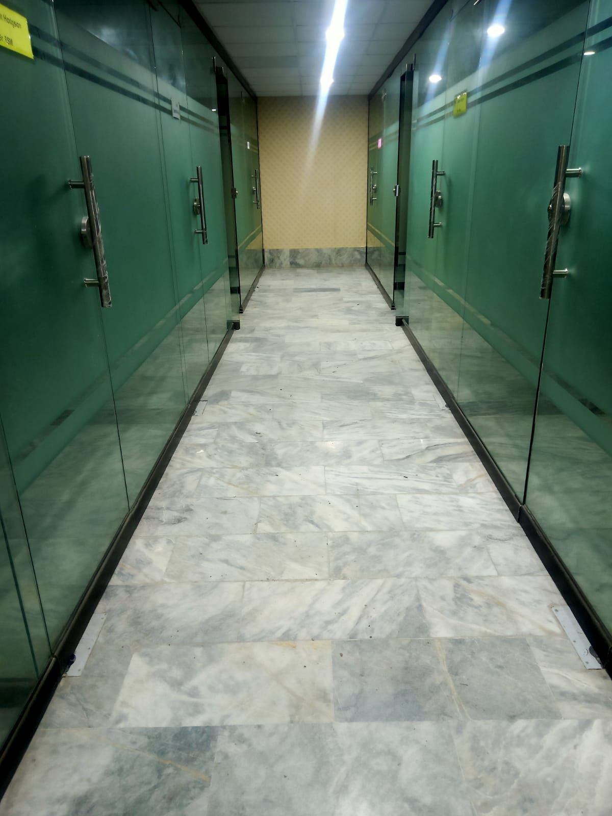 Corridor of glass-partitioned offices at the Sukkur branch