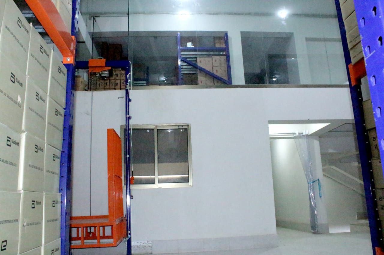 Warehouse goods lift beside the mezzanine storage level