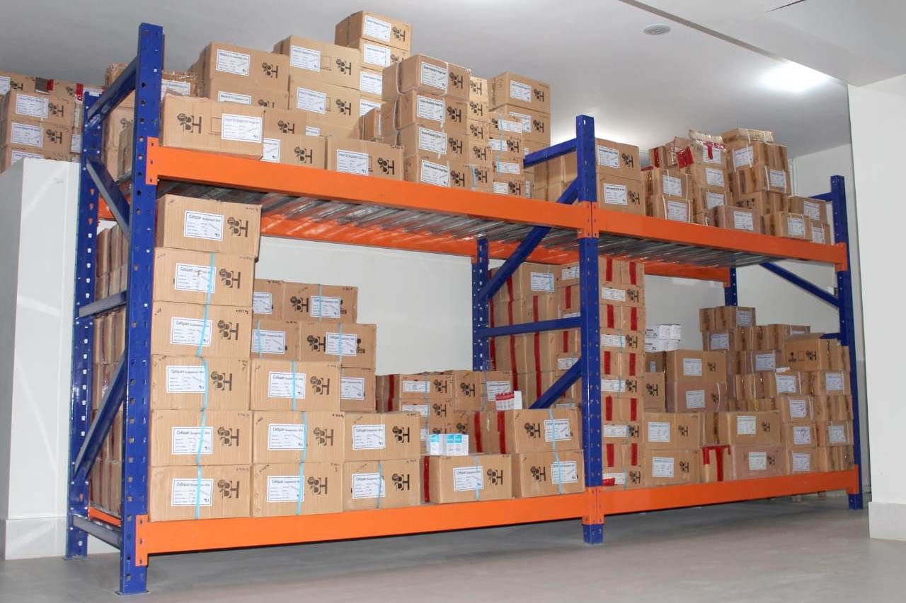 Two-tier pallet racking stocked with labelled pharmaceutical cartons